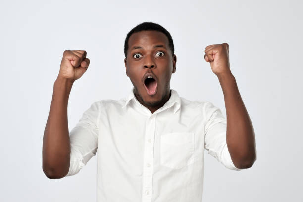 istock Young african man celebrating victory over gray background 1062101232