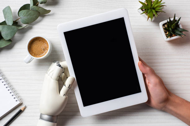 istock partial view of businessman with prosthesis arm using digital tablet with blank screen at table with coffee cup in office 1062105030