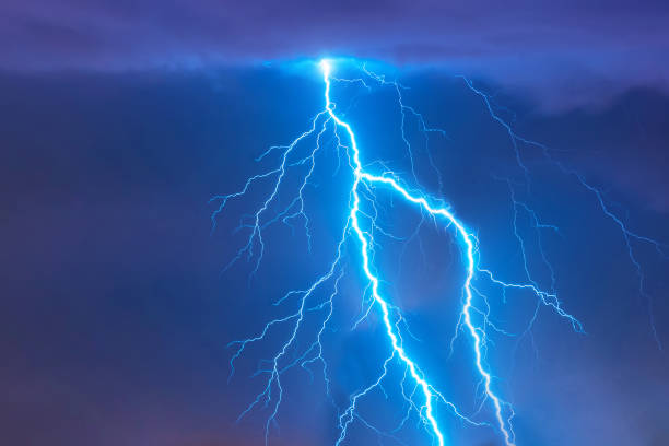 bright flash of lightning strike during a night thunderstorm in the sky. - summer landscape flash imagens e fotografias de stock