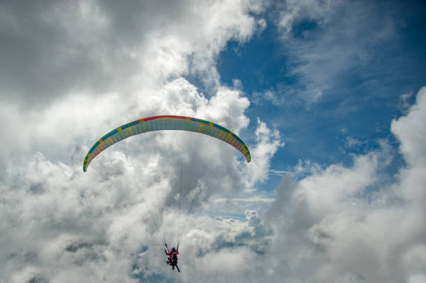istock Paraglider is flying in the clouds 1062109516