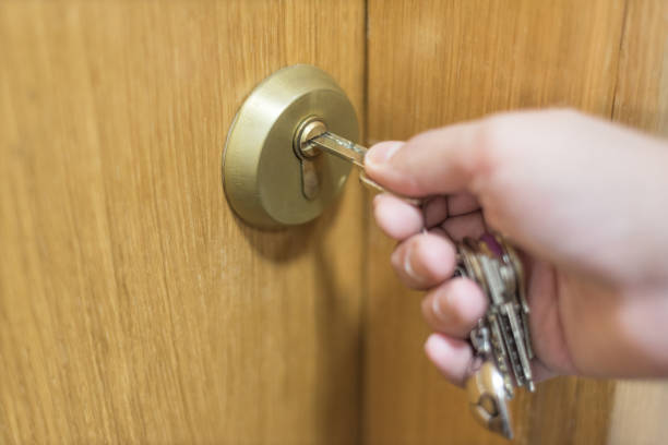 istock Hand Opening door with keys 1062110814