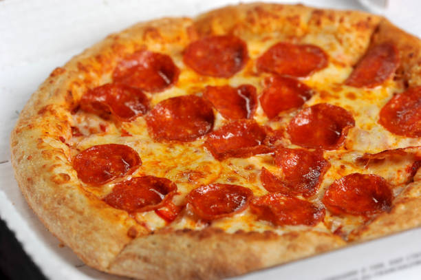 istock spicy pizza with sausages in a box 1062118322