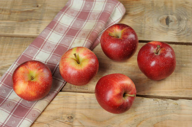 istock red juicy apples on wooden background 1062123400