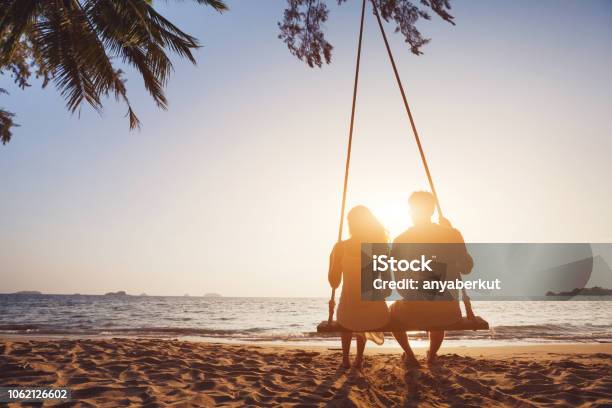 Honeymoon Travel Silhouete Of Couple In Love On The Beach Stock Photo - Download Image Now