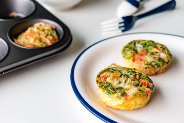 Egg muffins Healthy breakfast egg muffins with cheese, tomato and green veggetable, easy and healthy food concept frittata stock pictures, royalty-free photos & images