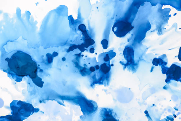 istock blue and light blue splashes of alcohol ink on white as abstract background 1062131294