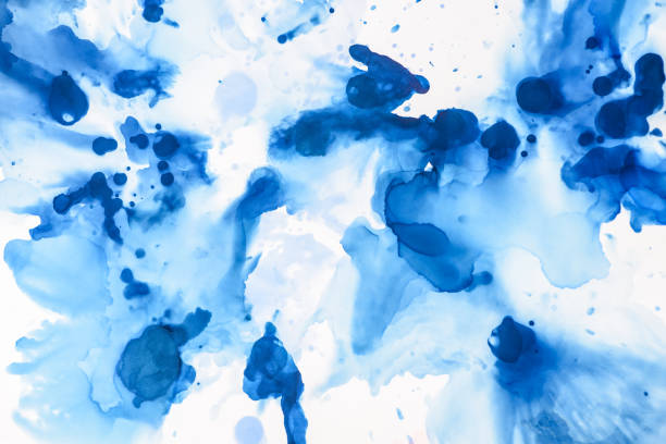 istock textured blue splashes of alcohol ink on white as abstract background 1062131318