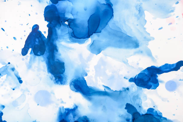 istock blue splashes of alcohol ink on white as abstract backdrop 1062131424