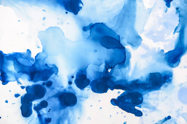 istock beautiful blue splashes of alcohol ink on white as abstract background 1062131458