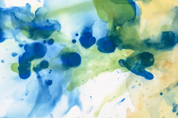 istock textured green and blue splashes of alcohol inks as abstract background 1062131568
