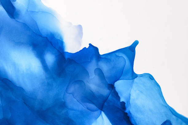 istock blue splashes of alcohol ink on white as abstract background 1062131936