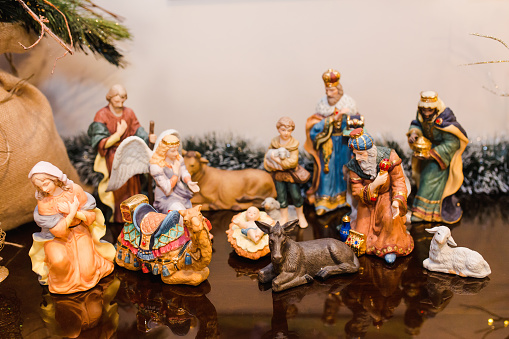 Three wise kings visiting Mother Mary and baby Jesus. Christmas decorations. Ceramic figurines. Interior design ideas.