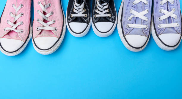istock three pairs of textile worn shoes on a blue background 1062132826