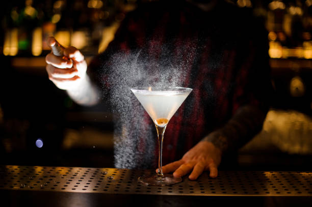 istock Barman spraying bitter on the elegant glass with fresh martini 1062139670