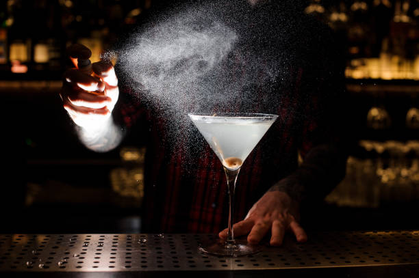 istock Bartender spraying bitter on the elegant glass with fresh martini 1062141254