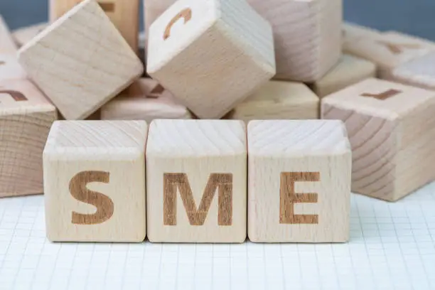 SME, small and medium-sized enterprises concept, cube wooden block with alphabet combine the word SME, entrepreneur business.