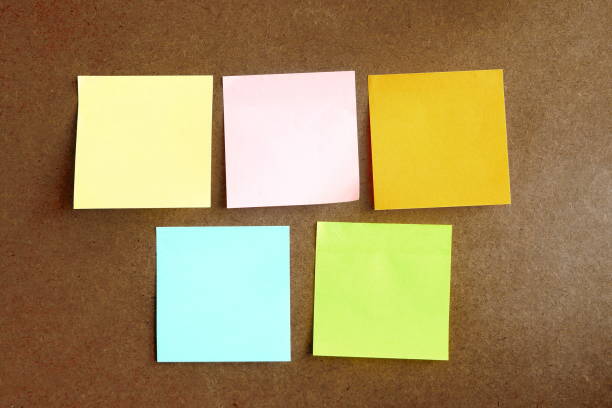 istock colorful post it paste on brown wood background have copy space for put text to do list 1062154154
