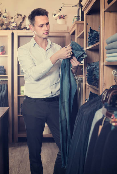 istock Young man is choosing on new pants 1062158078
