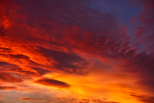 horizontal nature background of sky in fire colors, red, orange, yellow.