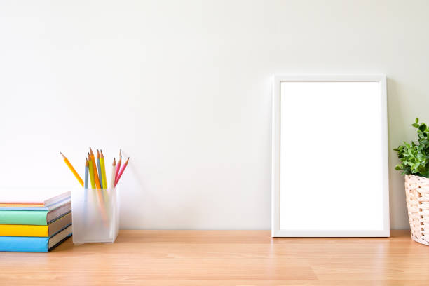 istock Mock up of photo frame on working table. 1062160738