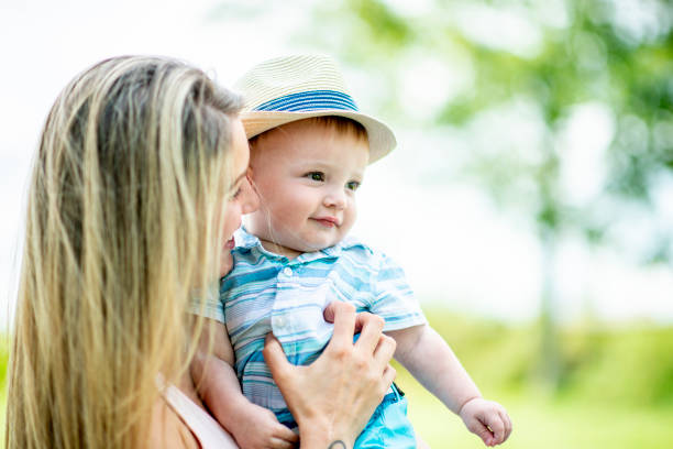 istock Mom holding son in the park 1062164670