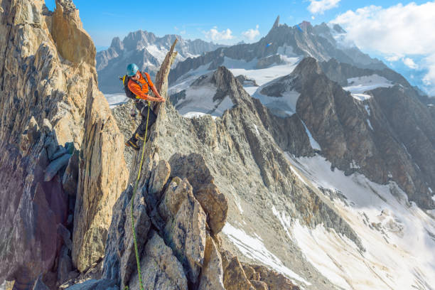 alpinist in the mountains - conquering adversity wilderness area aspirations achievement imagens e fotografias de stock
