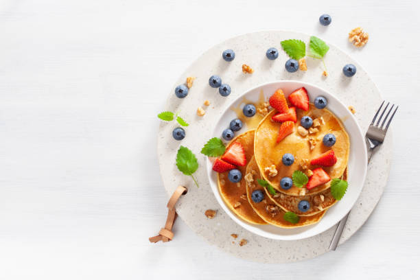 istock pancakes with blueberry strawberry honey and nuts for breakfast 1062172520