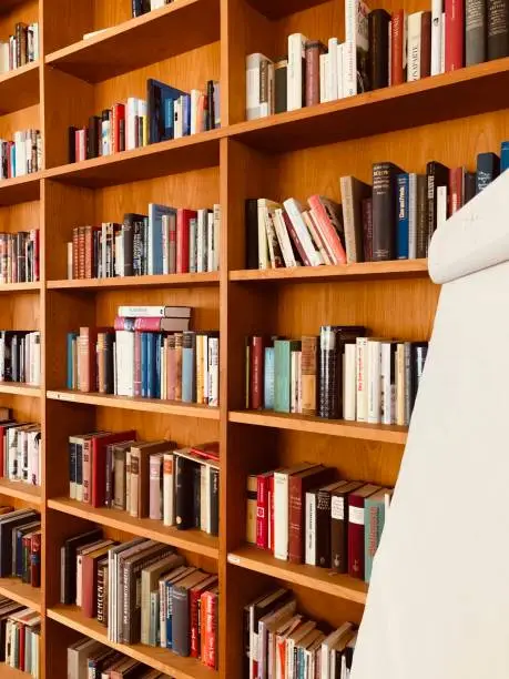 Bookshelves and the edge of a white memoboard
