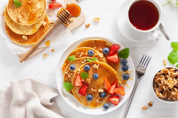 istock pancakes with blueberry strawberry honey and nuts for breakfast 1062173814