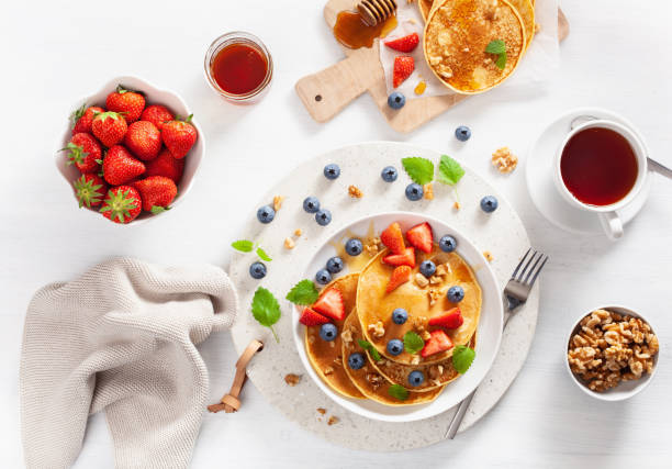 istock pancakes with blueberry strawberry honey and nuts for breakfast 1062174060