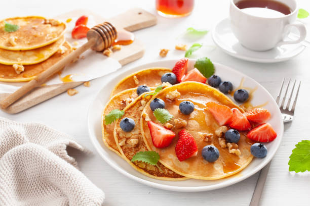 istock pancakes with blueberry strawberry honey and nuts for breakfast 1062174222