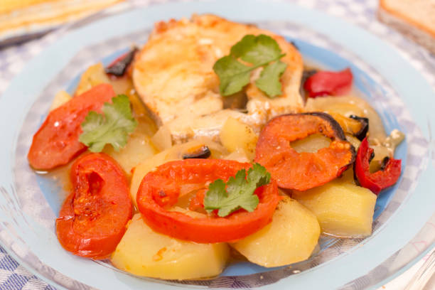 istock fish with potatoes and tomato 1062174454
