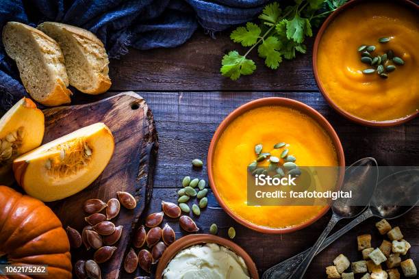 Pumpkin Soup With Ingredients On Rustic Wooden Table Stock Photo - Download Image Now