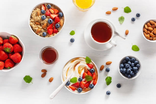 yogurt with strawberry blueberry honey almond and quinoa for breakfast - norway maple imagens e fotografias de stock