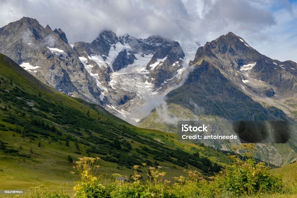 Rocky cliff with snow, and green grass in Jura mountain, France. Jura - France Stock Photo