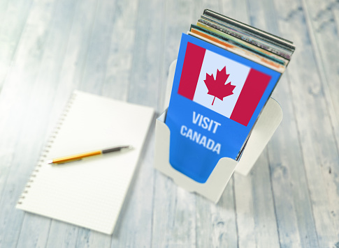 Planning a trip to Canada with a leaflet holder and pen and paper