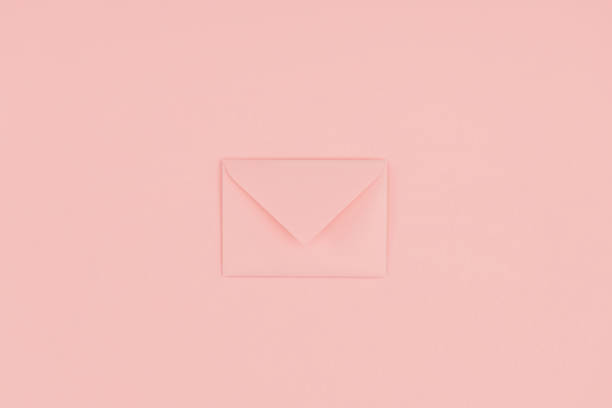 istock close-up view of single closed pink envelope isolated on pink 1062188160