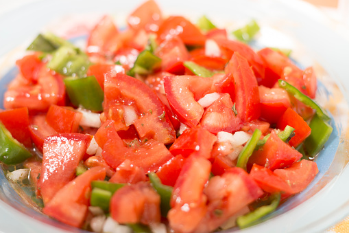 Fresh tomato and bell pepper salad typical of Portuguese cuisine.