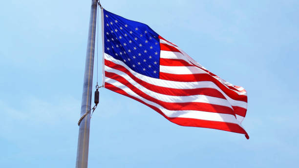 istock Low angle view of us flag in sunny day 1062188882