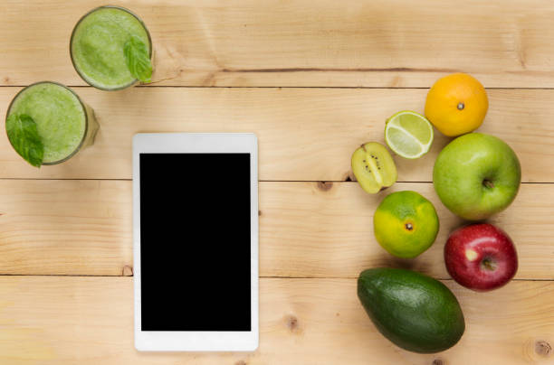 istock Healthy Green Vegetables and Smoothie with digital tablet 1062189700