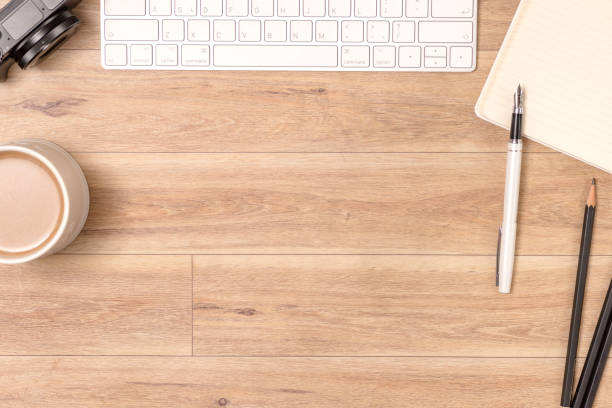 istock Wood office desk table with laptop, glasses, notebook, pen. Top view, copy space. 1062197674
