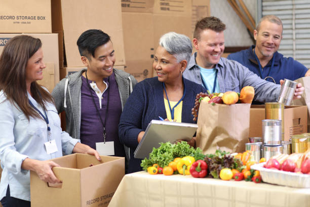 istock Multi-ethnic group of volunteers work at food bank. 1062201032