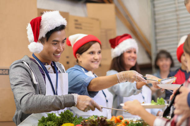 istock Multi-ethnic volunteers serves food at soup kitchen at Christmas. 1062201112