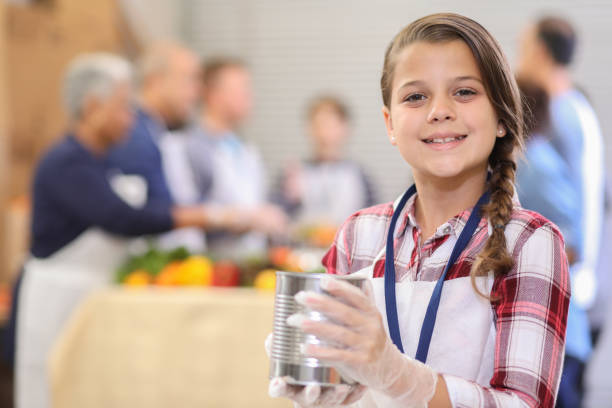 istock Multi-ethnic group of volunteers serves food at soup kitchen. 1062201476