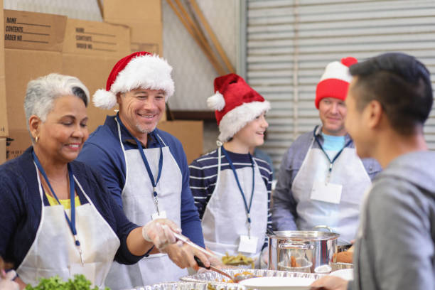 istock Multi-ethnic volunteers serves food at soup kitchen at Christmas. 1062201640