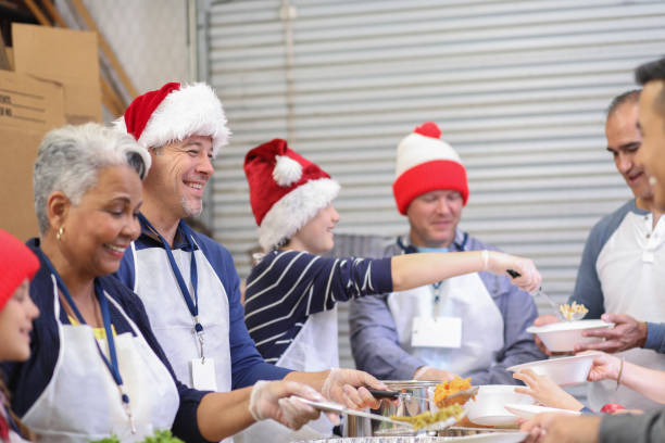 istock Multi-ethnic volunteers serves food at soup kitchen at Christmas. 1062201660