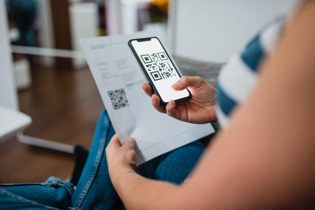 istock Woman scanning a bar code on a bill with a smart phone 1062204784