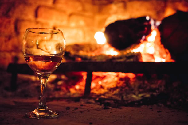 istock Wineglass heating up next to fireplace 1062205360
