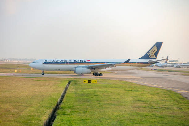 Singapore Airlines aircraft at Changi Airport in Singapore during sunrise.