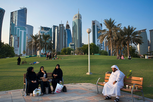 Families and modern skyline of the West Bay central financial district, Corniche promenade at Sheraton park Doha, Qatar, Middle East